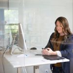 woman in black leather jacket using macbook air