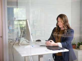 woman in black leather jacket using macbook air